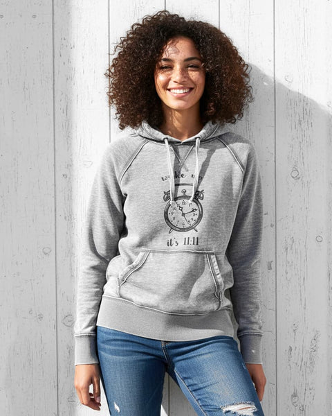 Woman wearing a gray vintage‑style hoodie with a distressed burnout fleece look and an 11:11 angel number clock design.