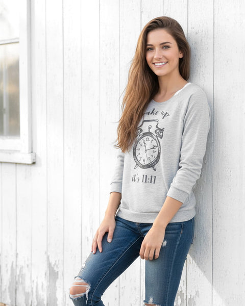 Woman wearing a heather gray wide‑neck shirt with a vintage 11:11 angel number clock design.