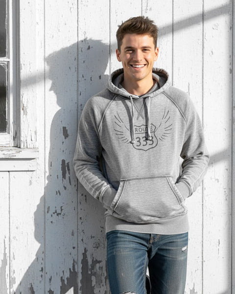 Man wearing a gray vintage‑style 333 angel number hoodie with a distressed, burnout fleece look.