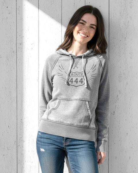 Woman wearing a gray vintage‑style 444 angel number hoodie with a distressed, burnout fleece look.