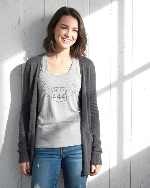 Woman wearing a heather gray 444 angel number tank top with a vintage, distressed look.
